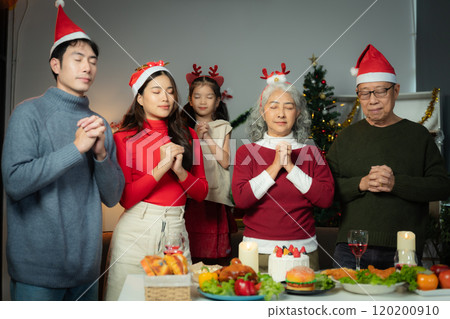 Dinner and Family holiday celebrating, together at Merry Christmas and  New Year. in a cozy festive home setting. 120200910