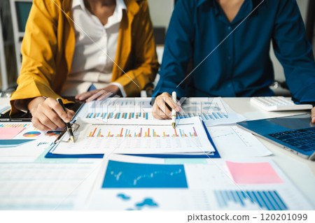 financial asian advisor showing plan of investment to clients in the consultancy office. 120201099