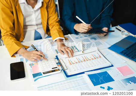 financial asian advisor showing plan of investment to clients in the consultancy office. 120201100