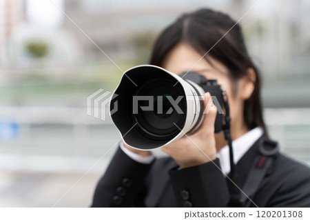 Female photographer in a suit 120201308