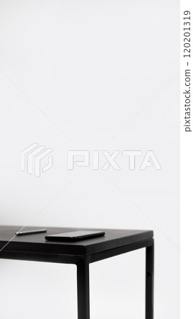 Minimal business background with a white table, vertical orientation. Features a smartphone, pen, and open space, creating a clean and modern look Minimal business background with a white table, vertical orientation. Features a smartphone, pen, and open space, creating a clean and modern look 120201319