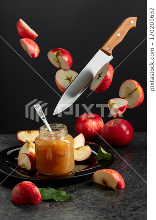 Apple jam and kitchen knife with red fresh apple slices. Apple jam and kitchen knife with red fresh apple slices. 120201632