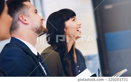 Seminars with humour are the best. Cropped shot of an attractive young businesswoman sitting with her colleagues while in the office during the day. 120201731