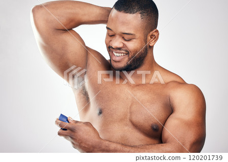 It keeps sweat under control and makes me smell great. Studio shot of a handsome young man spraying deodorant on his armpit against a white background. 120201739