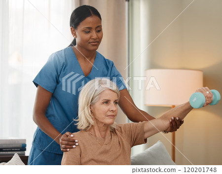 Living a better life with each lift. Shot of a senior woman using dumbbells during an exam with her doctor at home. Living a better life with each lift. Shot of a senior woman using dumbbells during an exam with her doctor at home. 120201748
