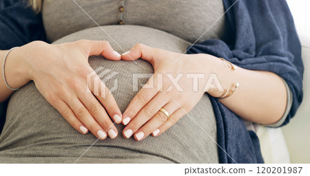 Moments in my belly, a lifetime in my heart. Shot of a pregnant woman making a heart frame on her belly at home. Moments in my belly, a lifetime in my heart. Shot of a pregnant woman making a heart frame on her belly at home. 120201987