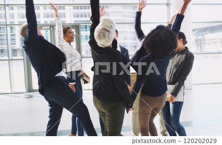 We did it. Cropped shot of a diverse group of businesspeople celebrating and throwing their hands up while in the office. 120202029