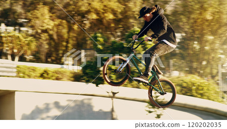 Some serious air. Full length shot of a young male BMX rider doing tricks around the city. Some serious air. Full length shot of a young male BMX rider doing tricks around the city. 120202035