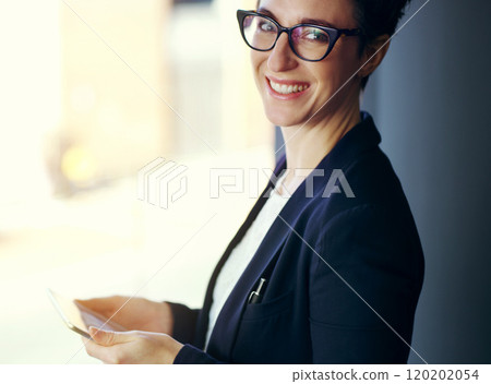 Its the best way to do business. Cropped portrait of an attractive young businesswoman working on a digital tablet while standing on her office balcony. 120202054
