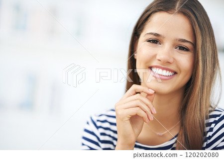 Her smile brightens up any room. Portrait of an attractive young woman relaxing at home. Her smile brightens up any room. Portrait of an attractive young woman relaxing at home. 120202080