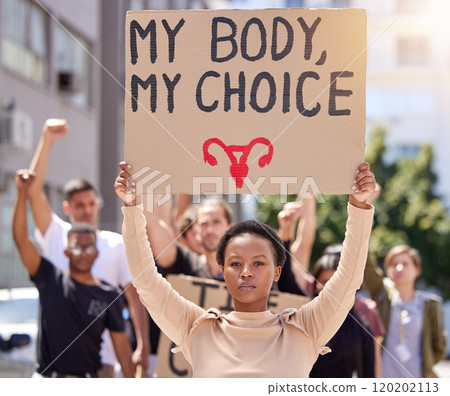 This is my body. Shot of a young woman at a rally holding a placard. 120202113
