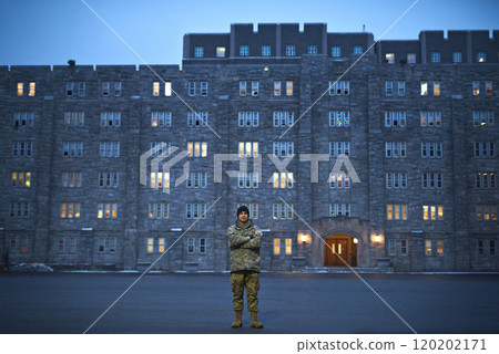 247 property protection. Shot of a young soldier standing outside on a cold day at military school. 120202171