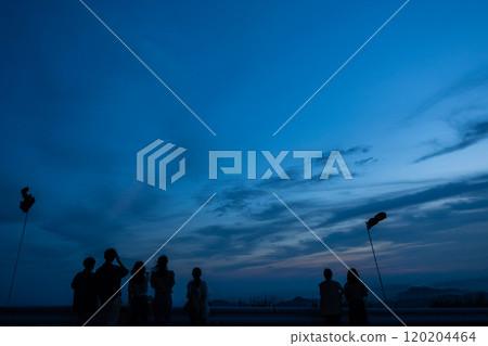 People looking down on the city from an observation deck at dusk 120204464
