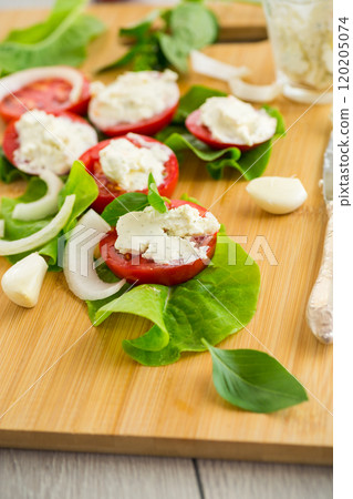 tomato wedges with cottage cheese filling and garlic, spicy appetizer 120205074
