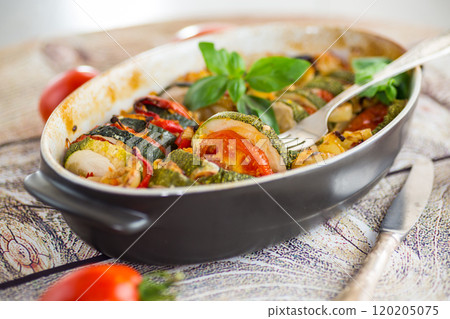 prepared baked zucchini and tomatoes in circles in a ceramic form, vegetable snack prepared baked zucchini and tomatoes in circles in a ceramic form, vegetable snack 120205075