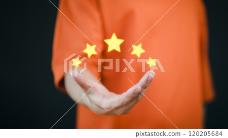 A customer or client's hand holds stars to complete a five-star rating, symbolizing service excellence. This image includes copy space and represents the concept of service rating and satisfaction. A customer or client's hand holds stars to complete a five-star rating, symbolizing service excellence. This image includes copy space and represents the concept of service rating and satisfaction. 120205684