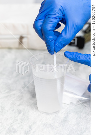 Healthcare Professional Preparing Glucose Solution for Tolerance Test Healthcare Professional Preparing Glucose Solution for Tolerance Test 120205794