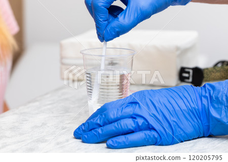 Healthcare Professional Preparing Glucose Solution for Tolerance Test 120205795
