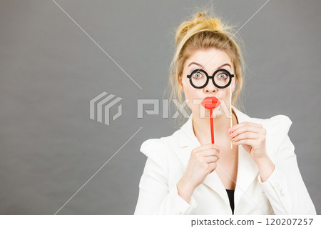 Happy elegant woman holding carnival accessoies on stick Happy elegant woman holding carnival accessoies on stick 120207257