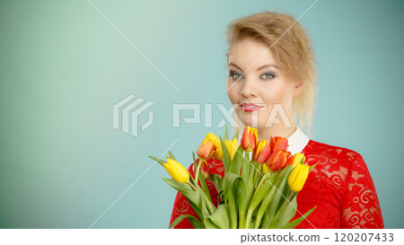 Pretty woman with red yellow tulips bunch 120207433