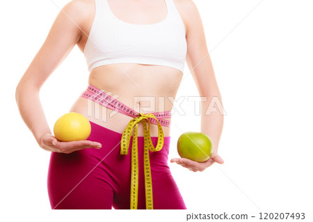 Diet. Fit girl with measure tapes citrus fruits 120207493