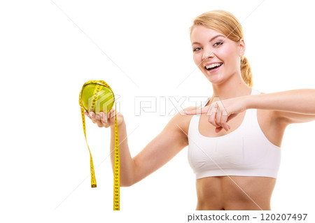 Happy woman holds grapefruit and measurement tape Happy woman holds grapefruit and measurement tape 120207497