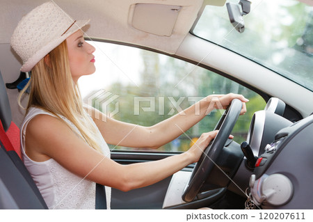 Pretty woman driving her car Pretty woman driving her car 120207611