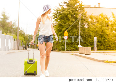 Attractive woman tourist walking with green suitcase Attractive woman tourist walking with green suitcase 120207623