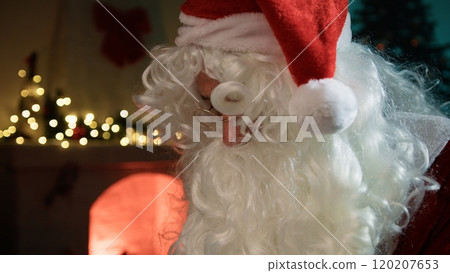Santa Claus Read The Letters Near The Fireplace In The Office 120207653