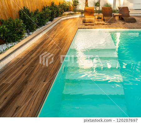 Swimming pool entrance steps with clean blue water at modern villa Swimming pool entrance steps with clean blue water at modern villa 120207697