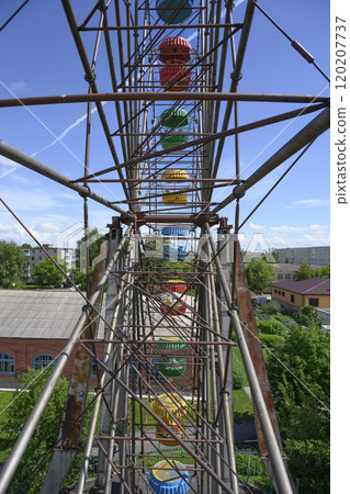 View of the Ferris wheel frame with colorful booths 120207737