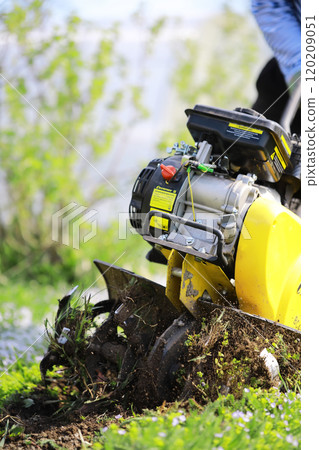 plowing the garden with special equipment on a spring morning 120209051