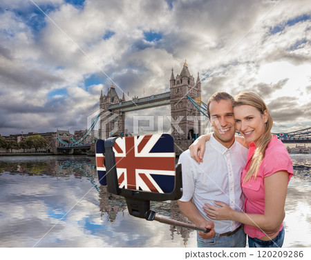 Couple in love taking a selfie portrait in front of Tower Bridge on their way around London, England, UK Couple in love taking a selfie portrait in front of Tower Bridge on their way around London, England, UK 120209286