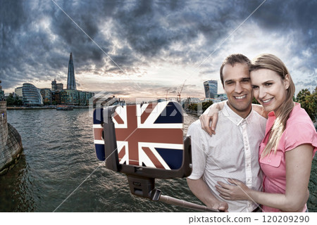 Couple in love taking a selfie portrait on the bridge with symbols of London on their way around London, England 120209290