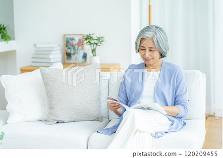 在客廳讀書的高級婦女 120209455