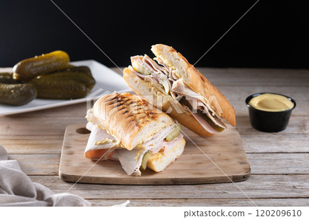 Traditional Cuban sandwich on wooden table 120209610
