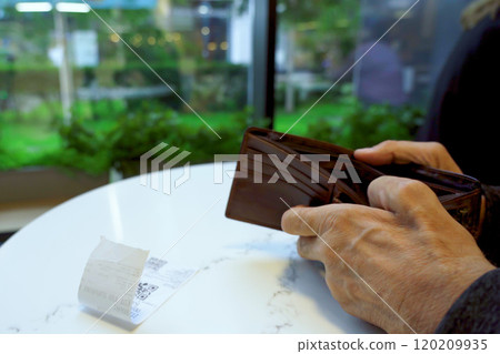 Senior man's hands holding order receipt and wallet 120209935