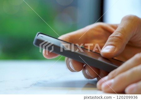 Close-up of hand males looking at smartphone.  120209936