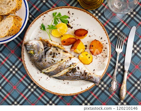 Dorado and potatoes baked in oven 120210146