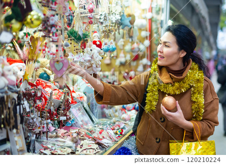 Female in tinsel on Christmas fair decoration on holiday 120210224