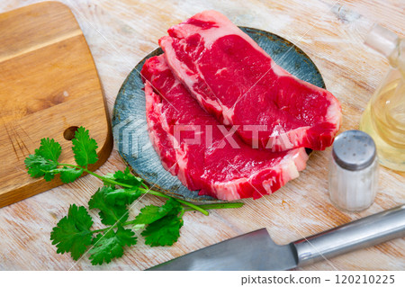 Raw veal tenderloin served with parsley Raw veal tenderloin served with parsley 120210225
