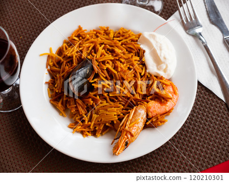Fideua, noodle paella with seafoods and alioli Fideua, noodle paella with seafoods and alioli 120210301