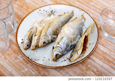 Dried roaches served on wooden table Dried roaches served on wooden table 120210397