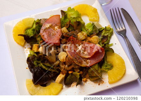 Tasty exotic salad from bacon, mushrooms and pineapple with cheese 120210398