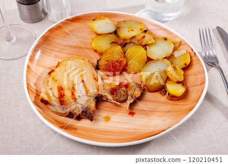 Grilled tasty pork meat with boiled potatoes served on table Grilled tasty pork meat with boiled potatoes served on table 120210451