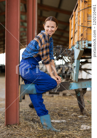 Adult female worker posing on farm Adult female worker posing on farm 120210461