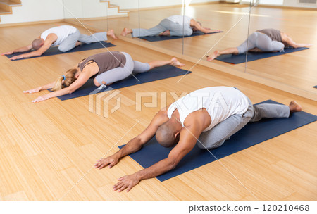 Group yoga class - pose (Balasana) 120210468