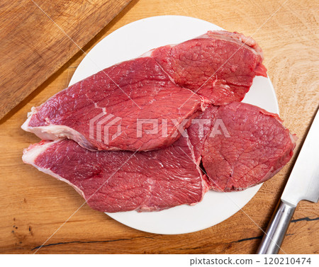 Raw beef veal meat steak tenderloin on board 120210474