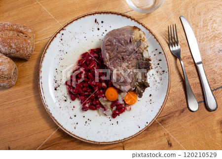 Delicious juicy fried pork belly with beans and stewed carrots closeup Delicious juicy fried pork belly with beans and stewed carrots closeup 120210529