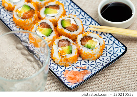 Japanese dish california roll masago with salmon, avocado, cheese and caviar closeup Japanese dish california roll masago with salmon, avocado, cheese and caviar closeup 120210532